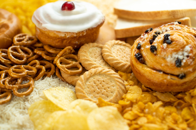variety of refined carbs including cookies, pastries, white bread, and chips