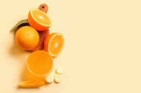 sliced oranges, orange juice, and vitamin C tablets