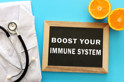 sign that says BOOST YOUR IMMUNE SYSTEM next to sliced orange and white lab coat with stethoscope